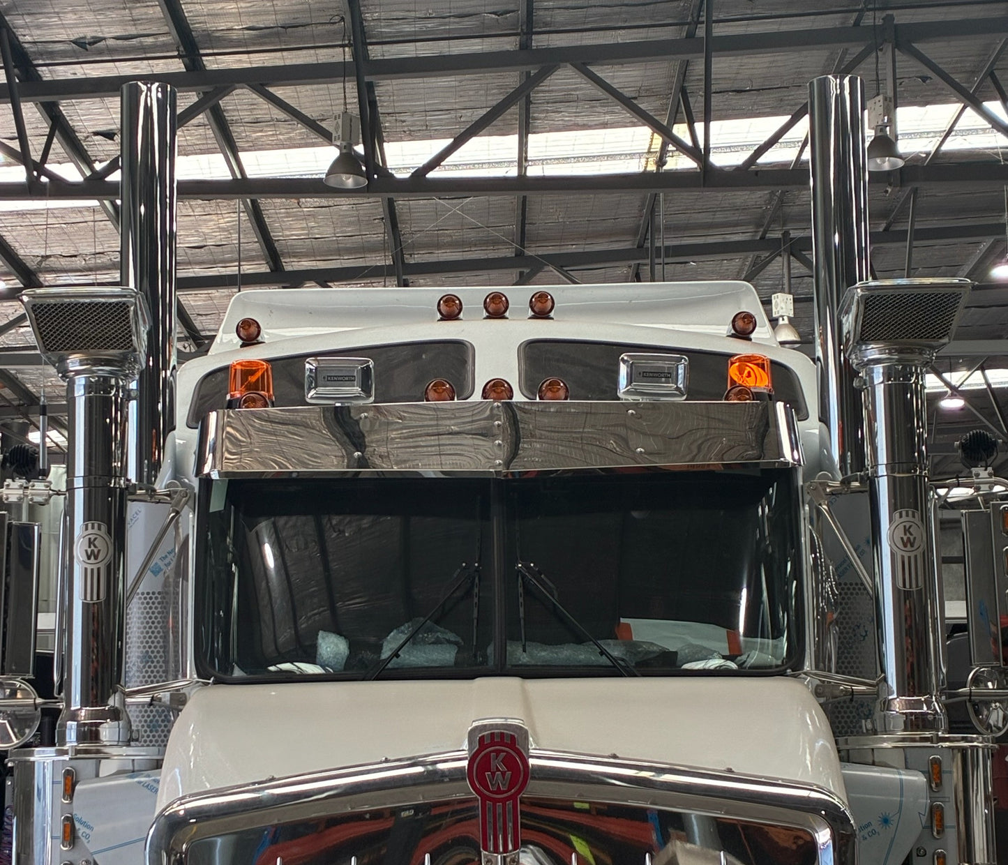 Kenworth T Series 12-inch drop visor by RTE Custom Trucks, showing a chrome truck visor mounted on a Kenworth T Series truck.