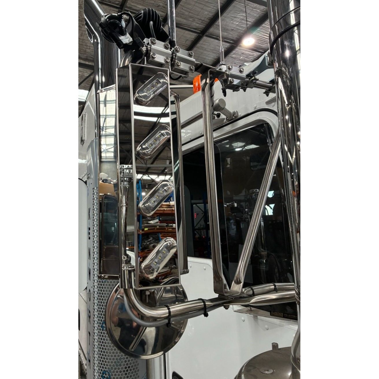 Stainless mirror trims with four lights, 45-degree angle, designed for RTE Custom Trucks, showcasing sleek finish and illumination.