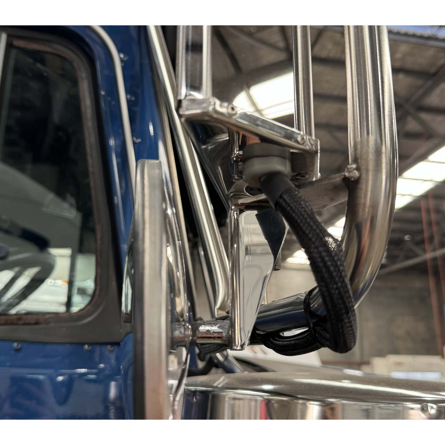 Heavy duty spotter mirror brackets by RTE Custom Trucks mounted on a vehicle, showcasing robust construction and design.