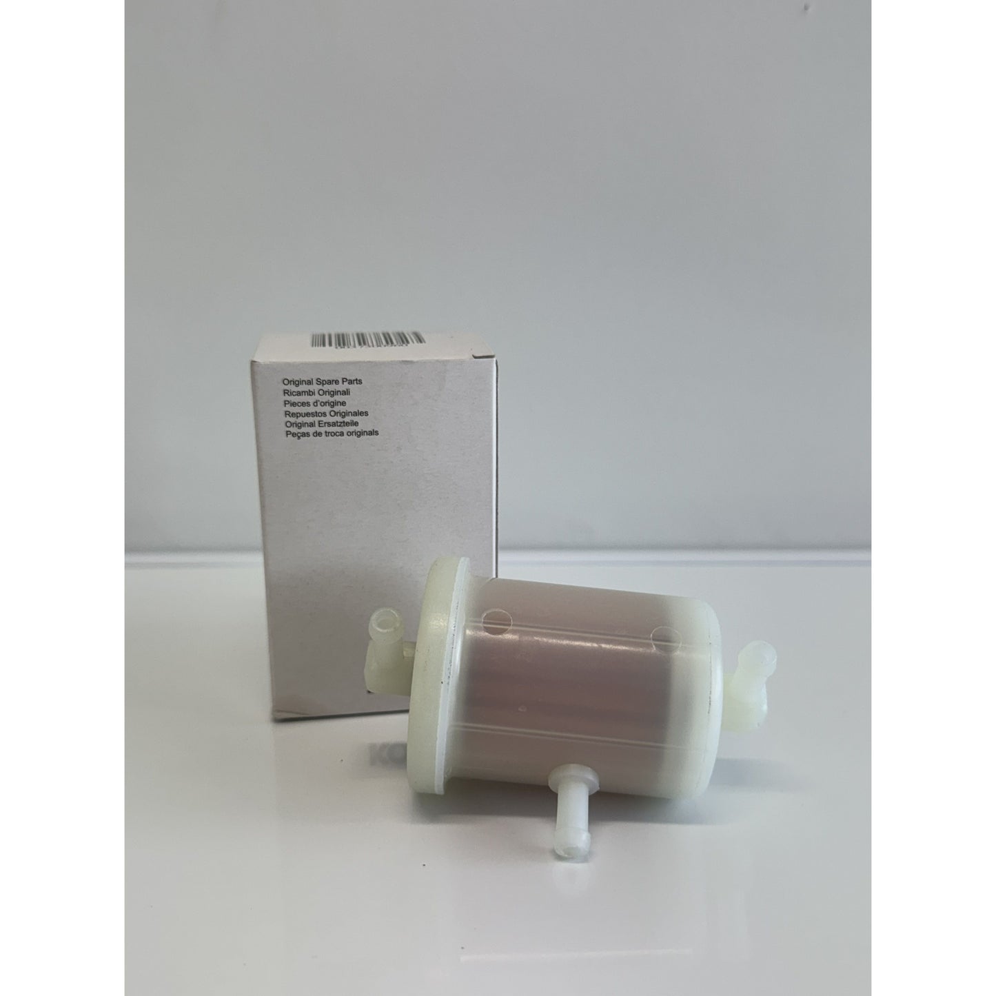 Kohler fuel filter by RTE Custom Trucks, showcasing a cylindrical design with inlet and outlet connections.