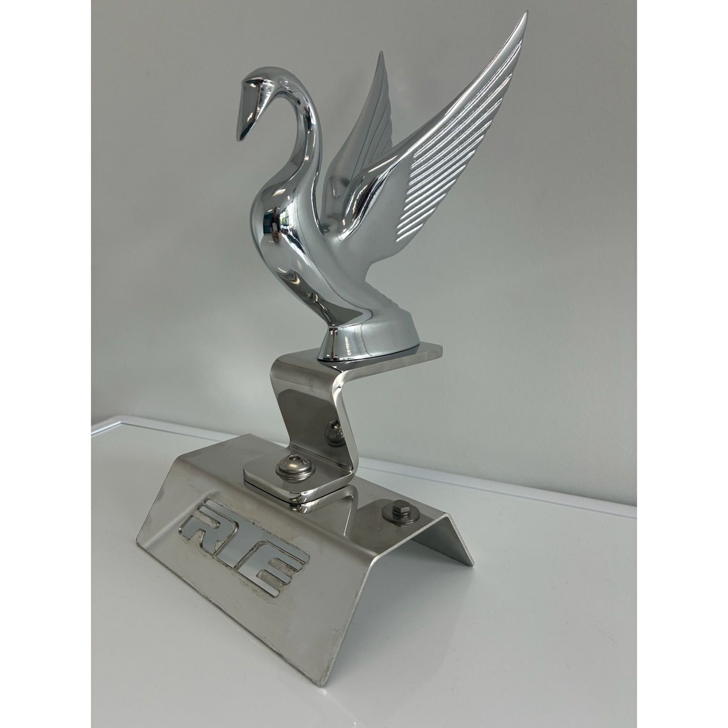 RTE Custom Trucks Swan Hood Ornament Mounting Bracket with durable metal design for secure ornament attachment.