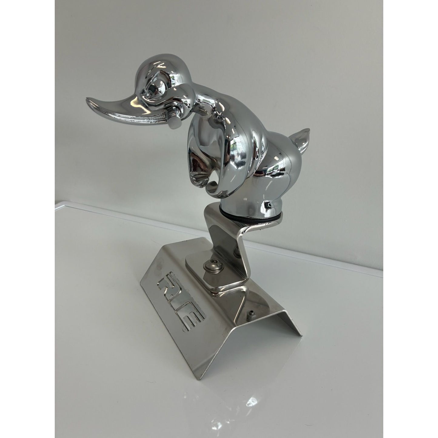 RTE Custom Trucks duck hood ornament mounting bracket with sturdy design for secure installation on vehicles.