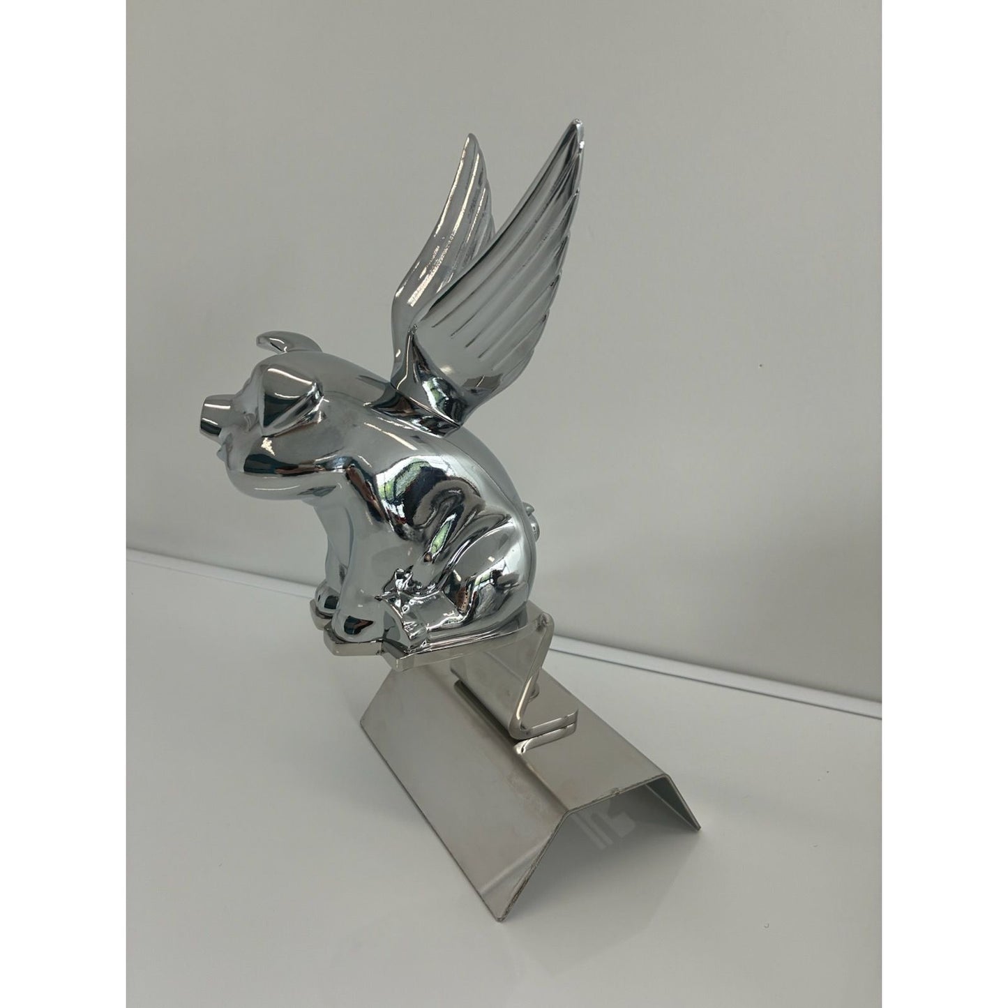RTE Custom Trucks pig hood ornament mounting bracket mounted on a vehicle, showcasing sturdy design and fit.