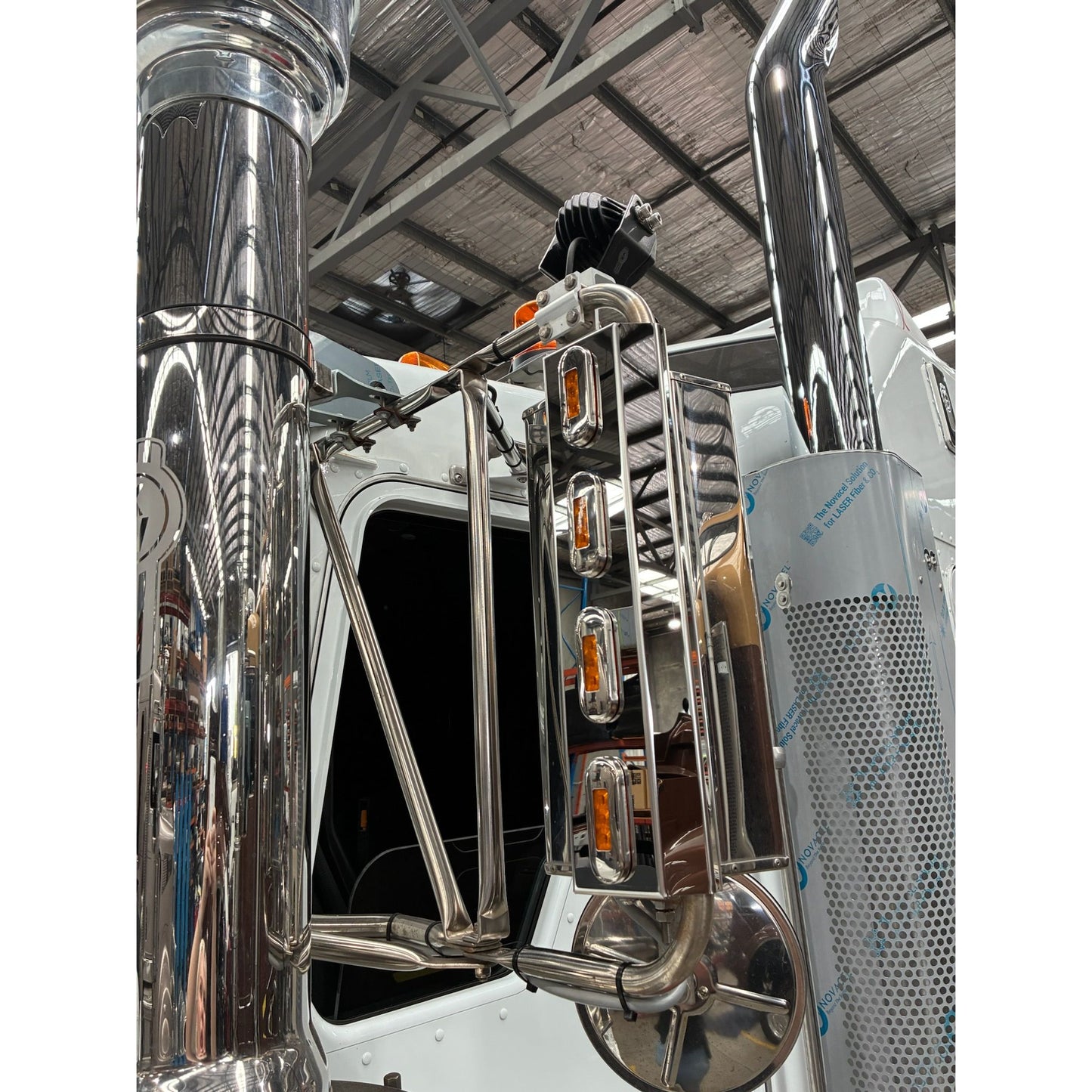 Stainless mirror trims with four lights by RTE Custom Trucks, showcasing a sleek design and polished finish.