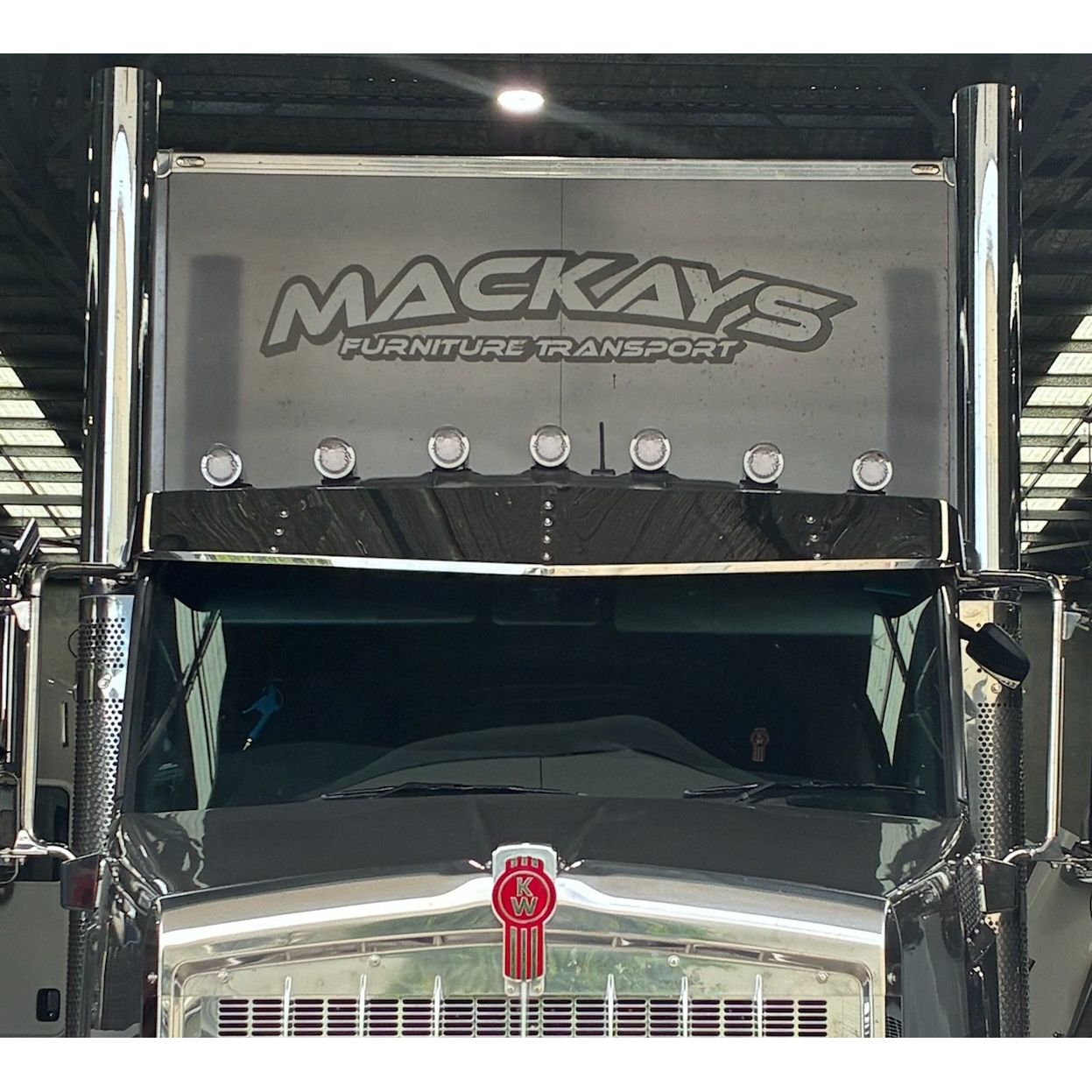 RTE Custom Trucks Kenworth T610/T410 12" mid roof cab visor mounted on a truck, showcasing sleek design and fit.